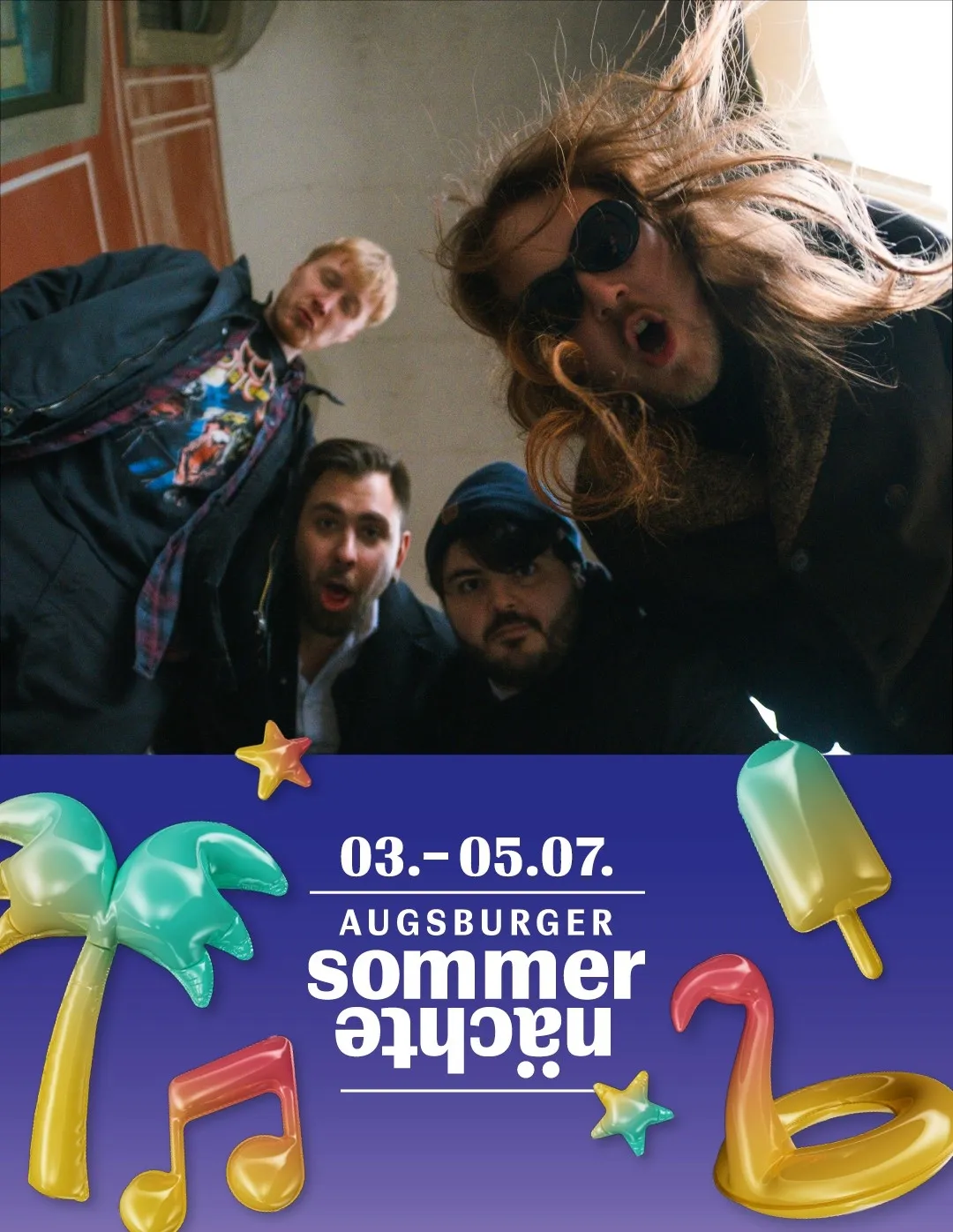 A band selfie on top of the Augsburger Sommernächte festival poster