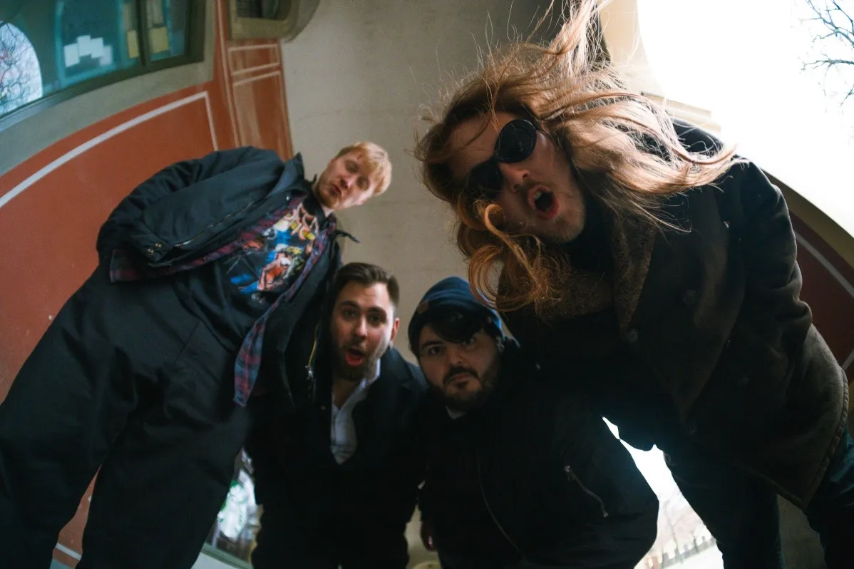 The band, shot from below with a fisheye lens, one of us mid hair-flip